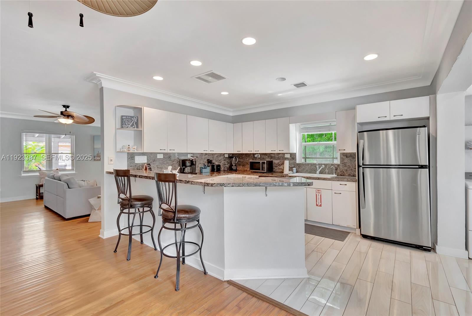 515 Southwest 9th Street Fort Lauderdale, FL 33315 - Photo 11 of 18 a kitchen with white cabinets and stainless steel appliances