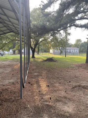 a view of backyard with large trees