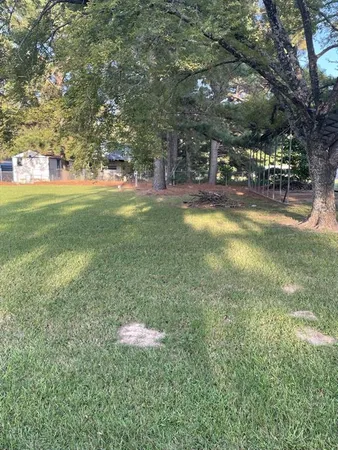 a view of yard with swimming pool