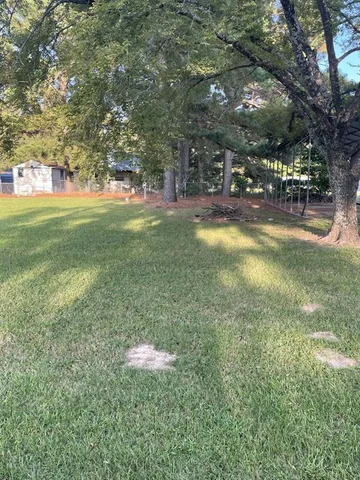 a view of yard with swimming pool