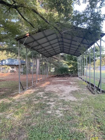 a view of a backyard with wooden fence