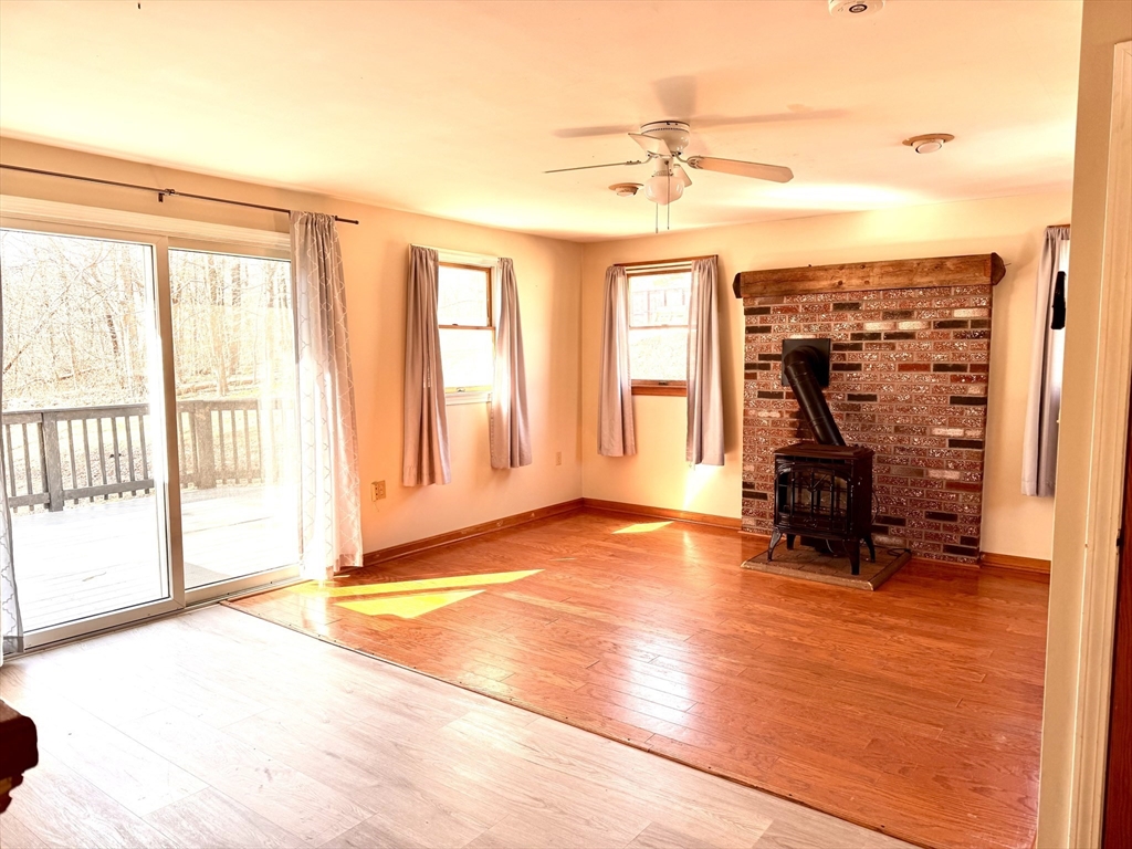 9 Redfield Road Cherry Valley, MA 01611 - Photo 11 of 35 a view of a livingroom with a patio and a fireplace