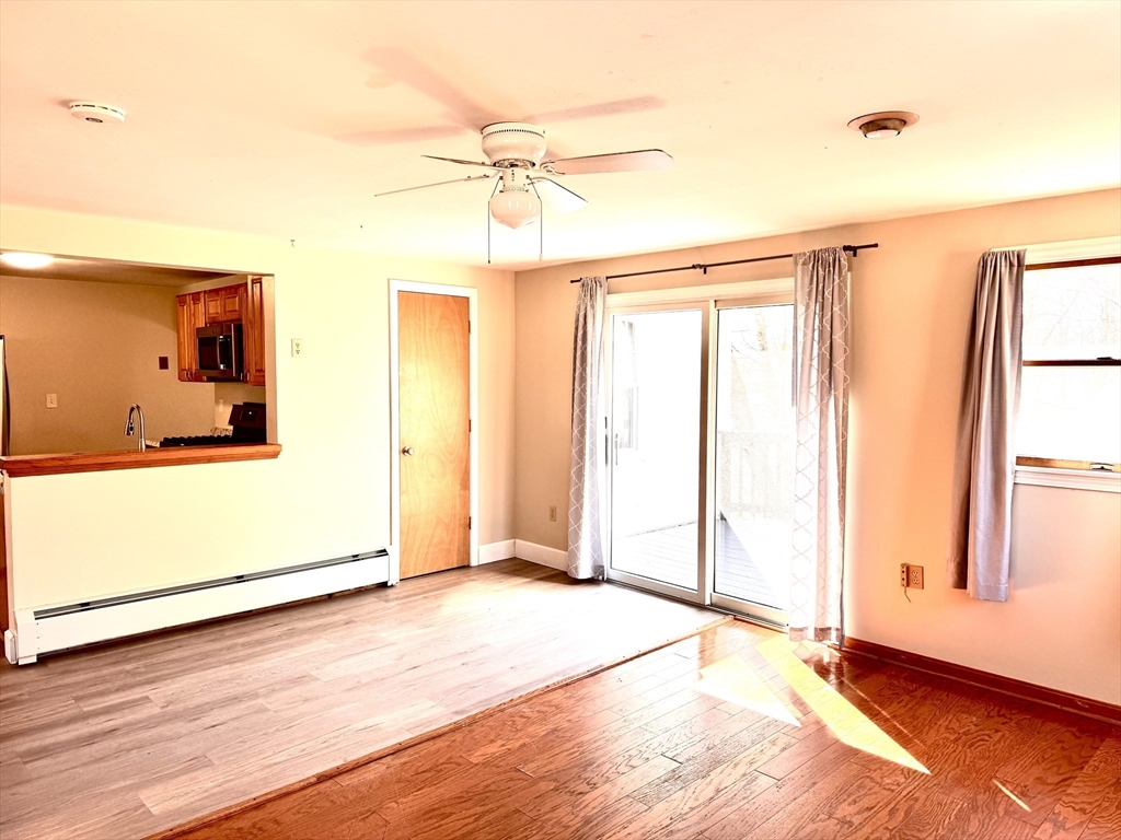 9 Redfield Road Cherry Valley, MA 01611 - Photo 13 of 35 a view of a livingroom with wooden floor and a ceiling fan