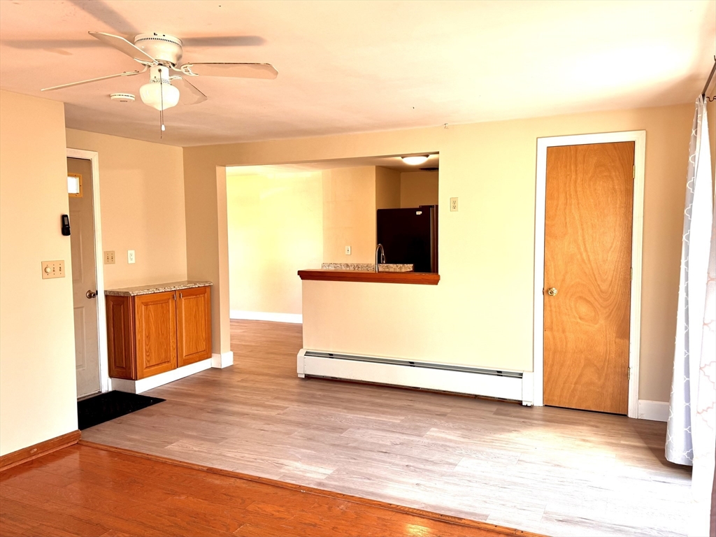 9 Redfield Road Cherry Valley, MA 01611 - Photo 14 of 35 a view of a room with wooden floor and a ceiling fan