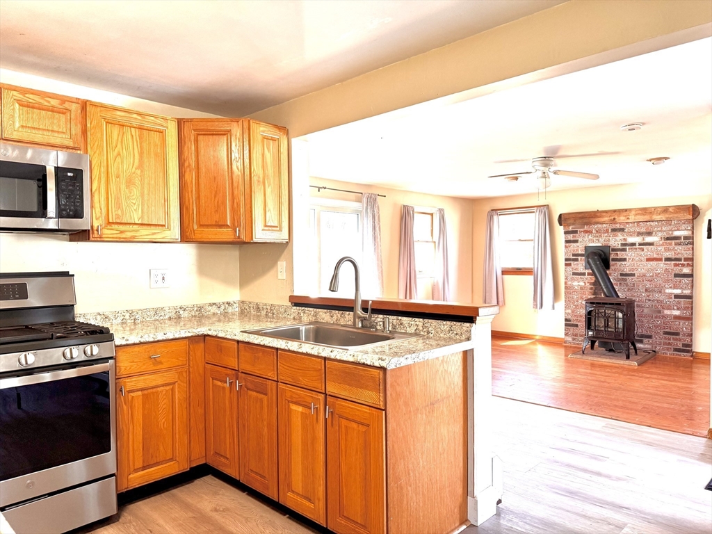 9 Redfield Road Cherry Valley, MA 01611 - Photo 16 of 35 a kitchen with stainless steel appliances granite countertop a stove a sink and a microwave