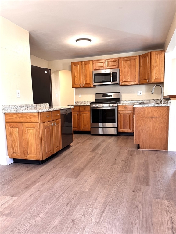 9 Redfield Road Cherry Valley, MA 01611 - Photo 18 of 35 a kitchen with stainless steel appliances a stove a sink and a microwave