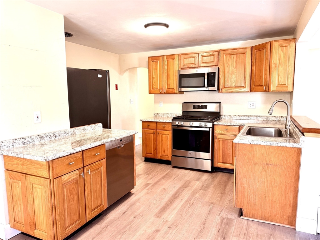 9 Redfield Road Cherry Valley, MA 01611 - Photo 20 of 35 a kitchen with stainless steel appliances granite countertop a stove top oven and sink