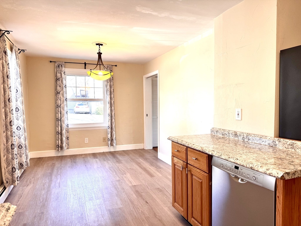 9 Redfield Road Cherry Valley, MA 01611 - Photo 21 of 35 a kitchen with granite countertop wooden floors and wide window