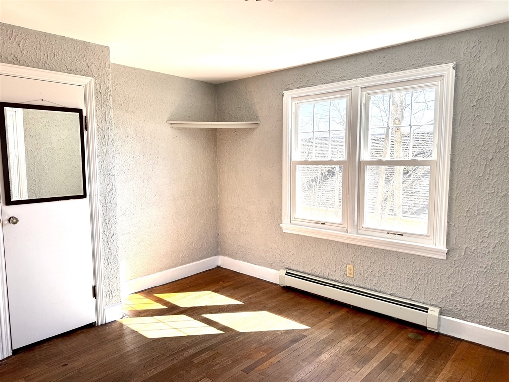 9 Redfield Road Cherry Valley, MA 01611 - Photo 23 of 35 an empty room with wooden floor and windows