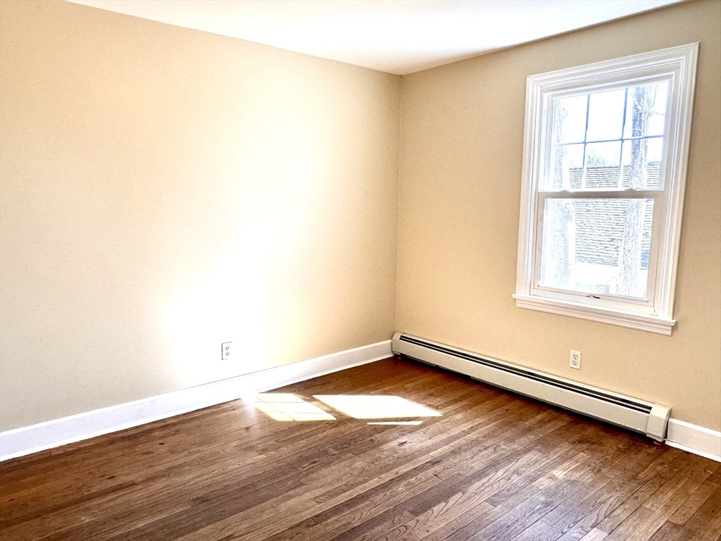9 Redfield Road Cherry Valley, MA 01611 - Photo 25 of 35 an empty room with wooden floor and windows