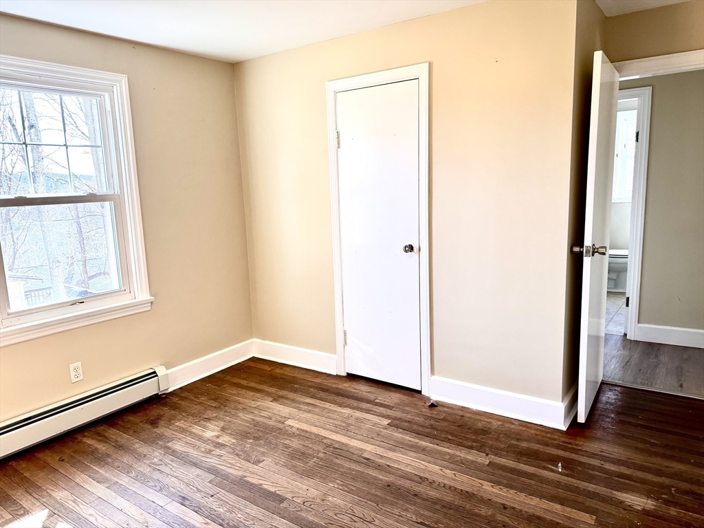 9 Redfield Road Cherry Valley, MA 01611 - Photo 26 of 35 an empty room with wooden floor and windows