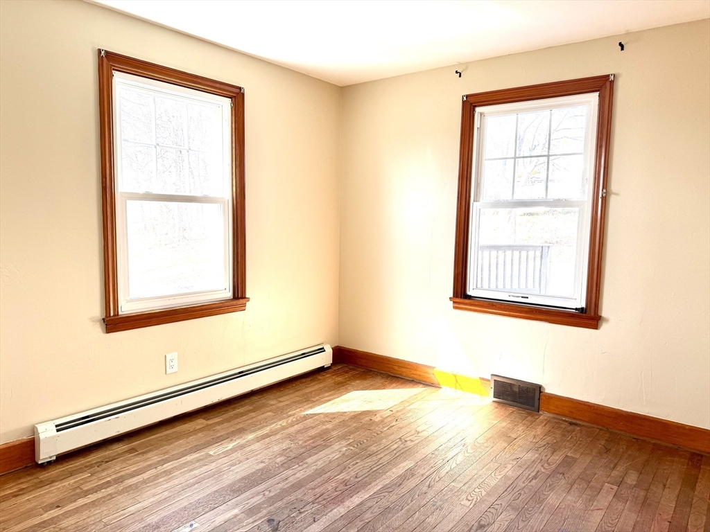9 Redfield Road Cherry Valley, MA 01611 - Photo 29 of 35 an empty room with wooden floor and windows