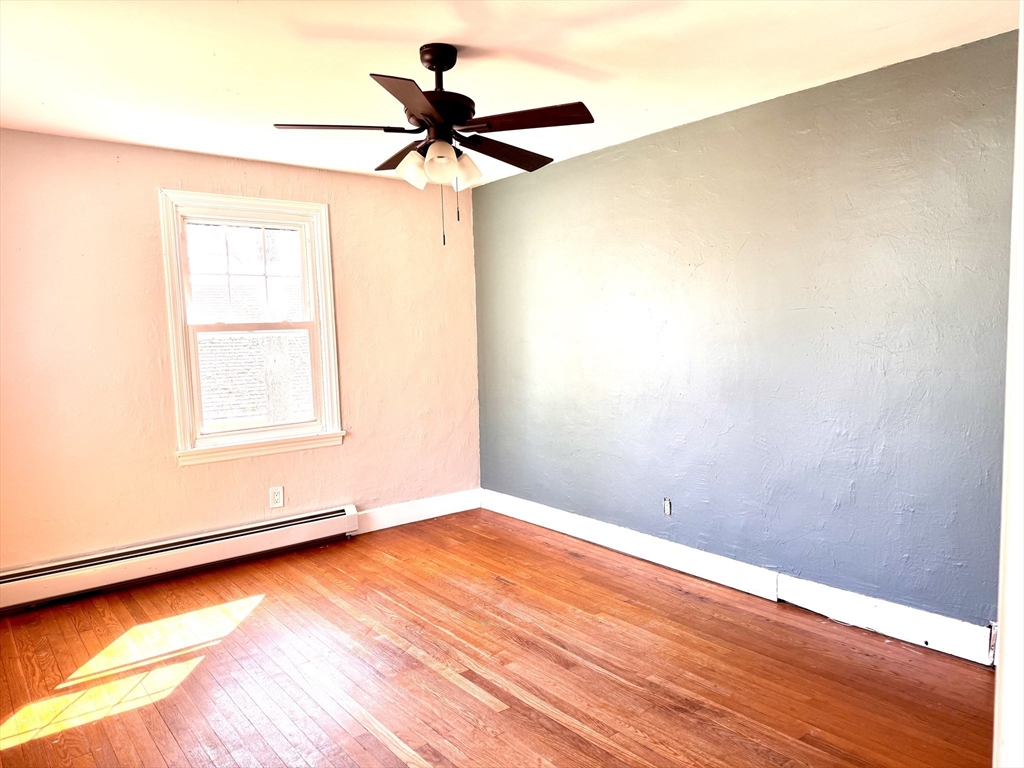 9 Redfield Road Cherry Valley, MA 01611 - Photo 30 of 35 an empty room with a window and a ceiling fan