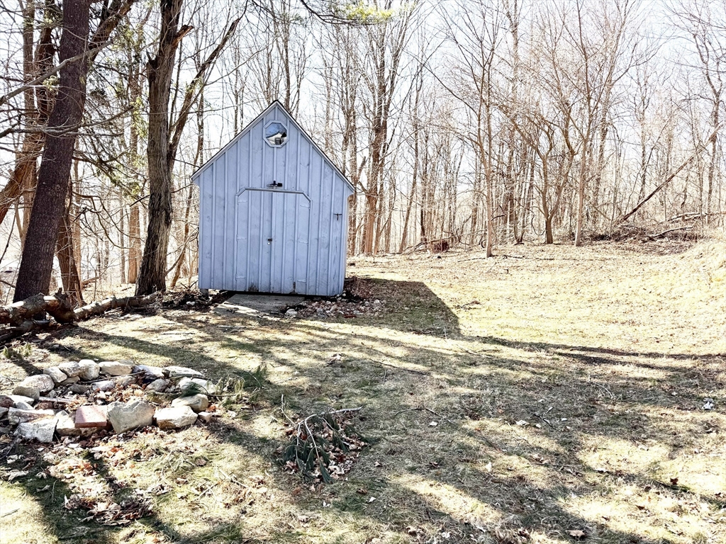 9 Redfield Road Cherry Valley, MA 01611 - Photo 34 of 35 a house view with a wooden fence and large trees