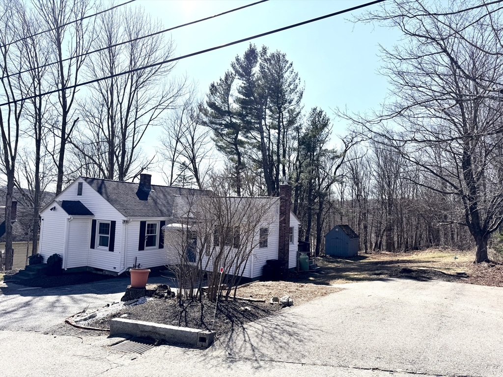 9 Redfield Road Cherry Valley, MA 01611 - Photo 6 of 35 a front view of house with yard covered in snow