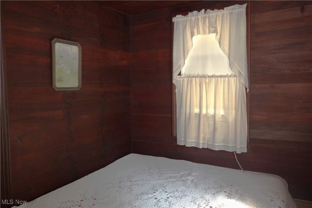 22760 Roy Croy Road Senecaville, OH 43780 - Photo 23 of 46 Upstairs Bedroom with wooden walls