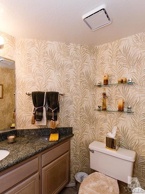 584 Fairfield Road Simi Valley, CA 93065 - Photo 12 of 26 a bathroom with a granite countertop toilet sink and mirror