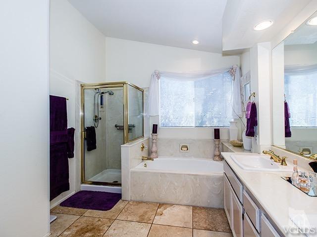 584 Fairfield Road Simi Valley, CA 93065 - Photo 16 of 26 a spacious bathroom with a tub sink and mirror