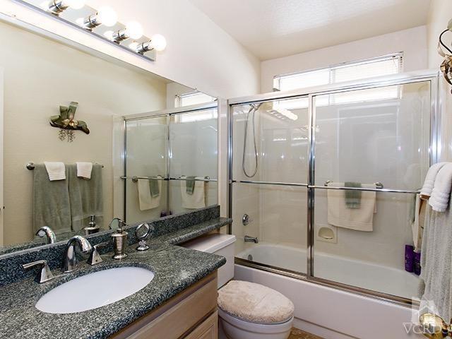 584 Fairfield Road Simi Valley, CA 93065 - Photo 22 of 26 a bathroom with a granite countertop sink toilet and shower