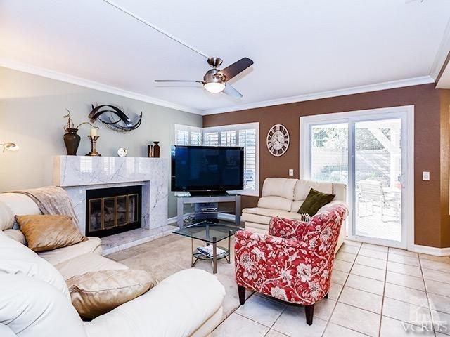 584 Fairfield Road Simi Valley, CA 93065 - Photo 6 of 26 a living room with furniture a fireplace and a flat screen tv