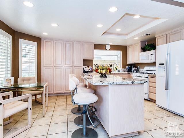 584 Fairfield Road Simi Valley, CA 93065 - Photo 7 of 26 a kitchen with refrigerator and chairs