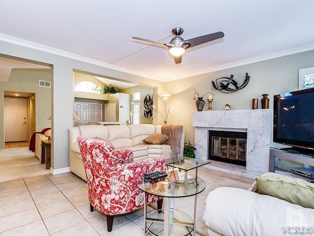584 Fairfield Road Simi Valley, CA 93065 - Photo 10 of 26 a living room with furniture a fireplace and a flat screen tv