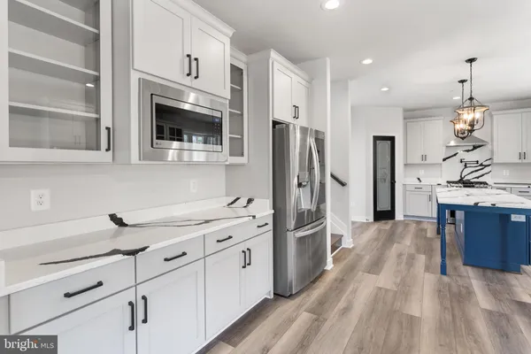 a kitchen with a sink stove and microwave
