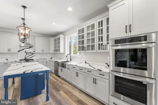 a kitchen with a sink stove and a refrigerator