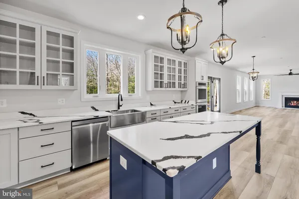a view of kitchen with stainless steel appliances refrigerator stove microwave and cabinets
