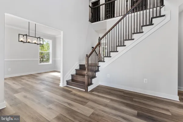 a view of entryway and hall with wooden floor