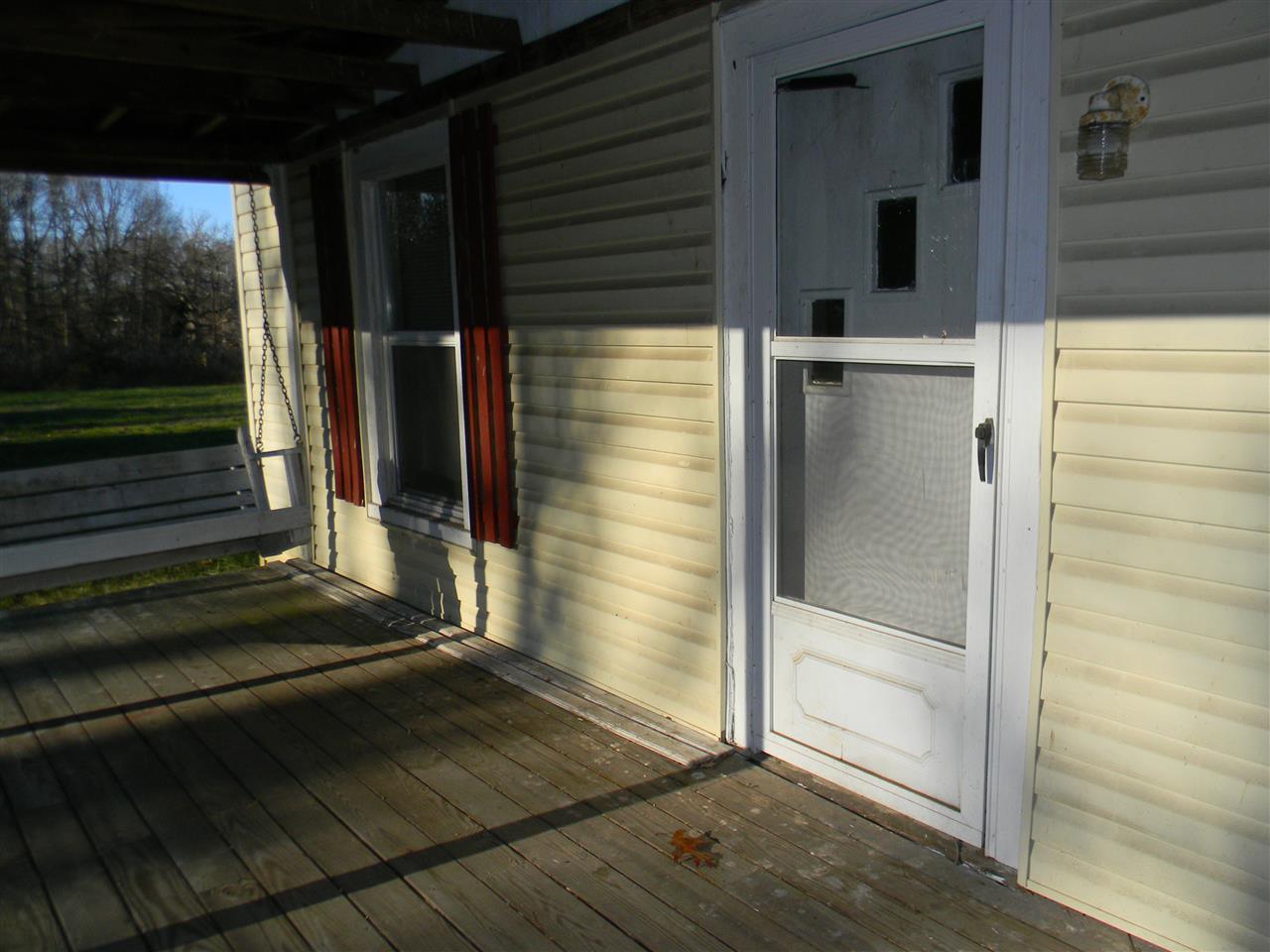 The country front porch sports 2 swings for relaxing and visiting with friends and family