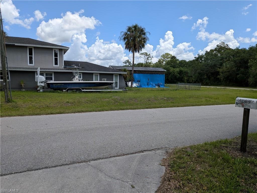 17191 Frank Road Alva, FL 33920 - Photo 4 of 27 a front view of a house with a yard and a garage