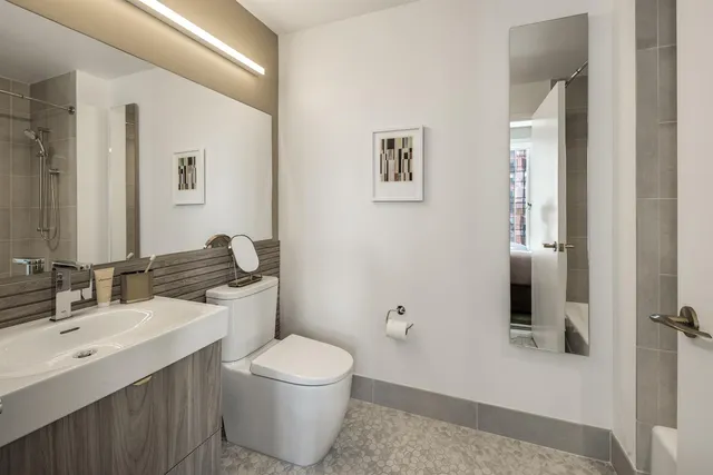 a bathroom with a sink toilet and shower