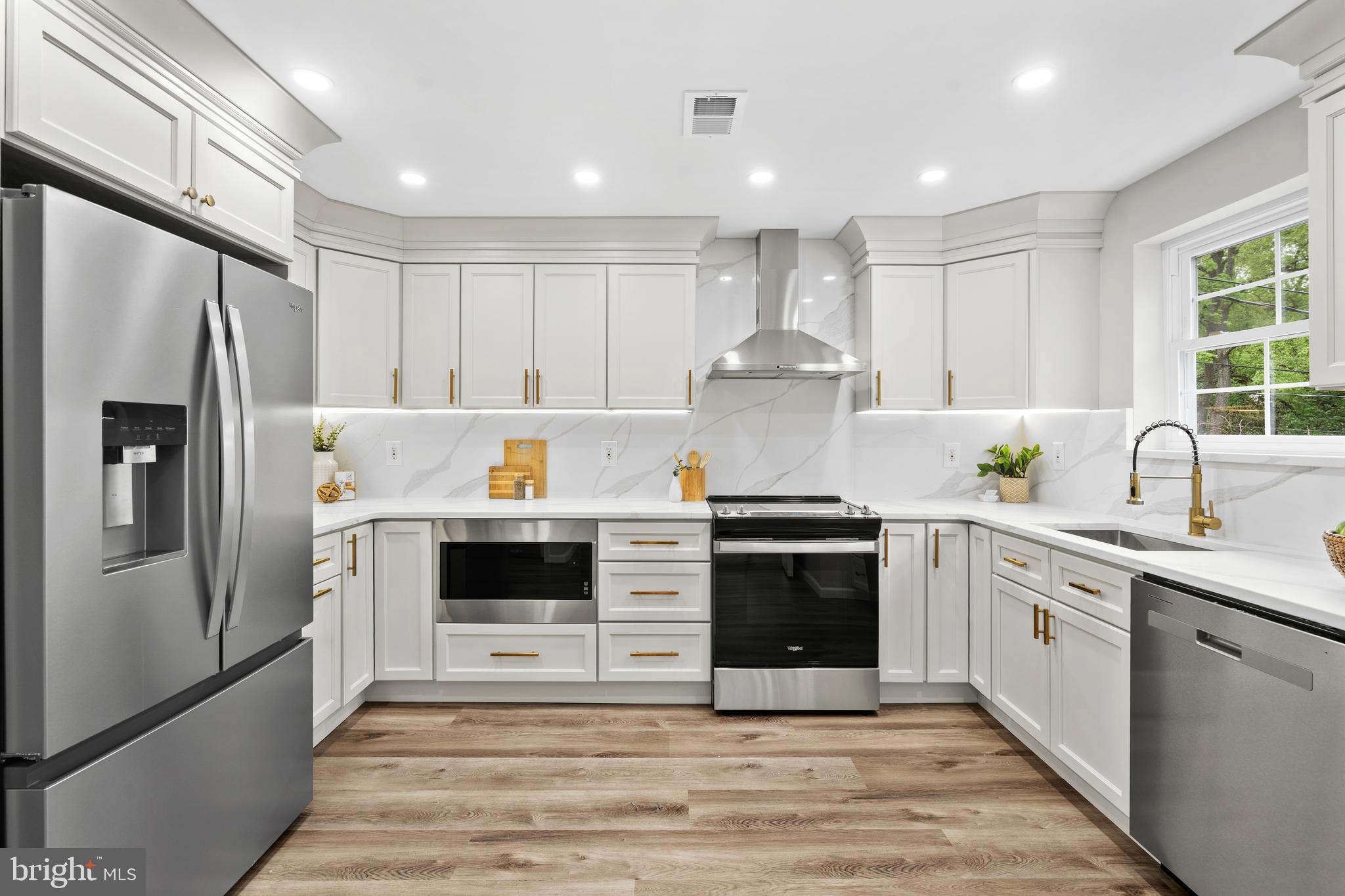 104 Atwood Road Flourtown, PA 19031 - Photo 11 of 52 a kitchen with a refrigerator sink and cabinets