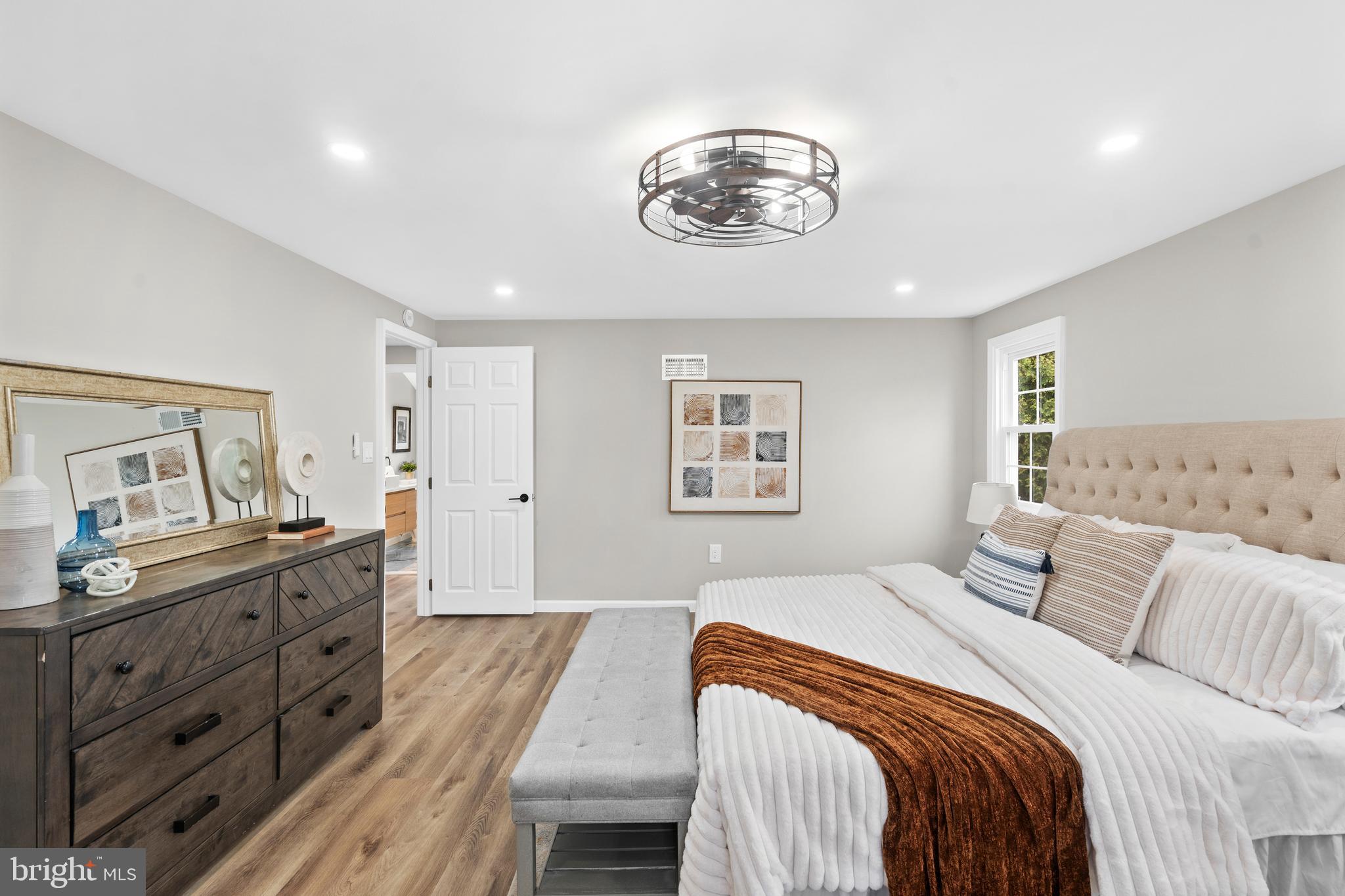 104 Atwood Road Flourtown, PA 19031 - Photo 21 of 52 a bedroom with a bed and a chandelier
