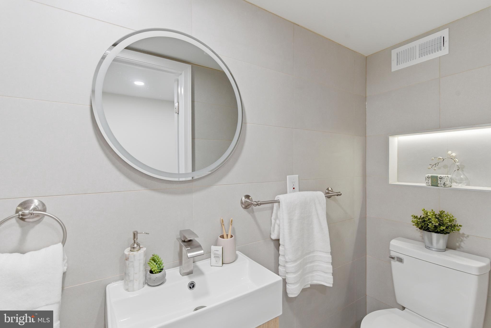 104 Atwood Road Flourtown, PA 19031 - Photo 45 of 52 a bathroom with a sink a toilet and a mirror