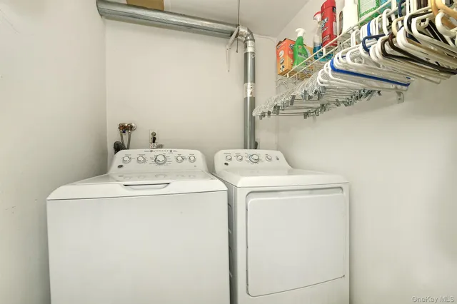a balcony with wooden floor table and chairs