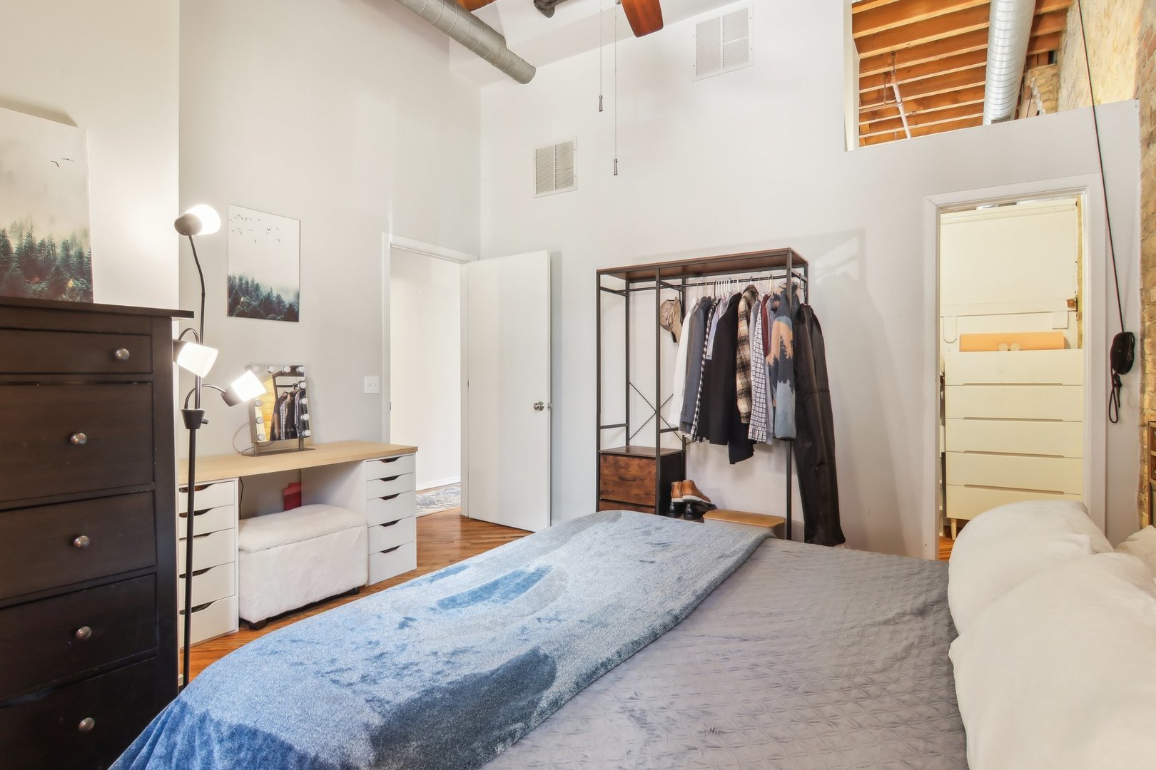 226 North Clinton Street, Unit 216 Chicago, IL 60661 - Photo 11 of 21 a bedroom with a bed and a dresser