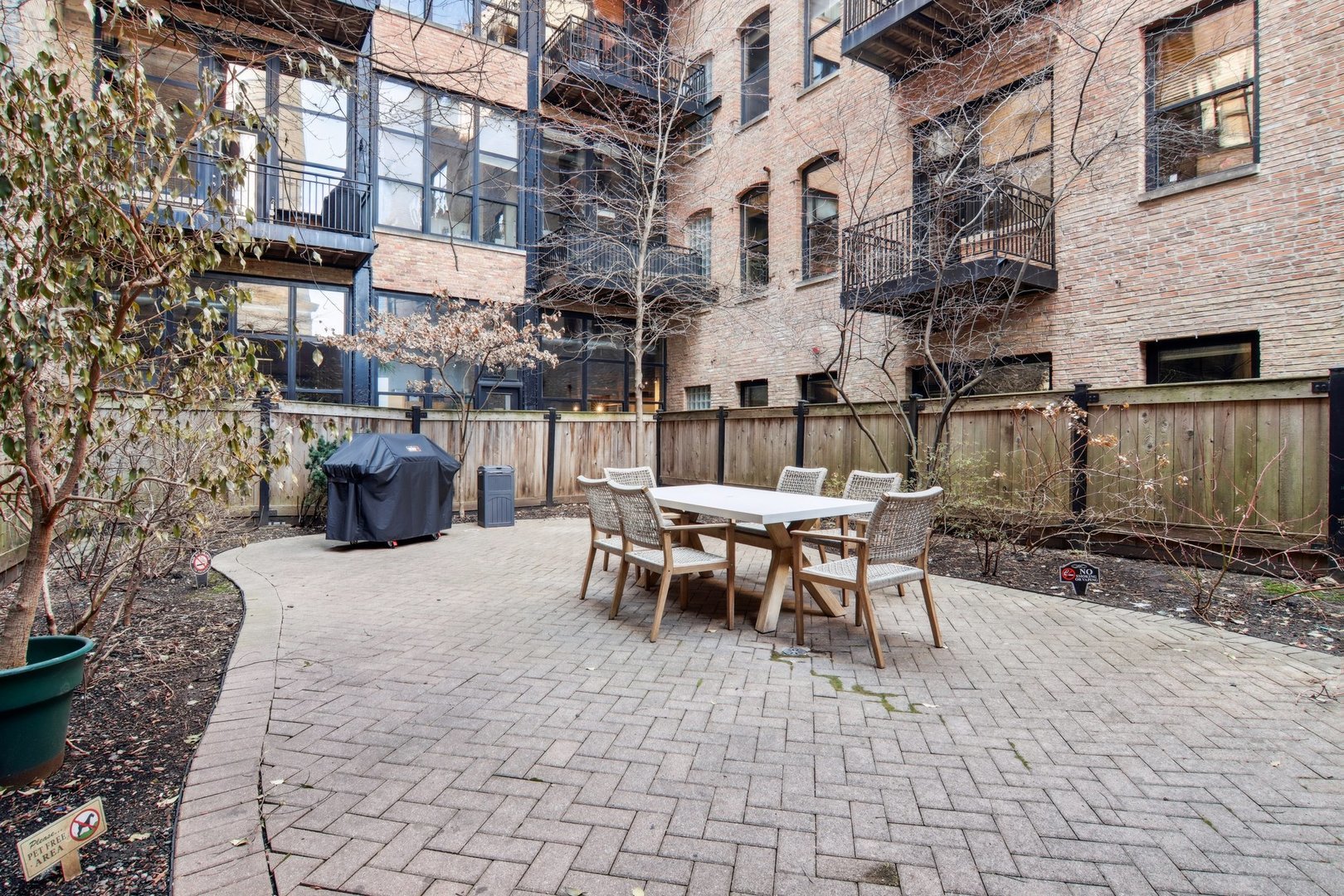 226 North Clinton Street, Unit 216 Chicago, IL 60661 - Photo 18 of 21 a view of a patio with a table and chairs