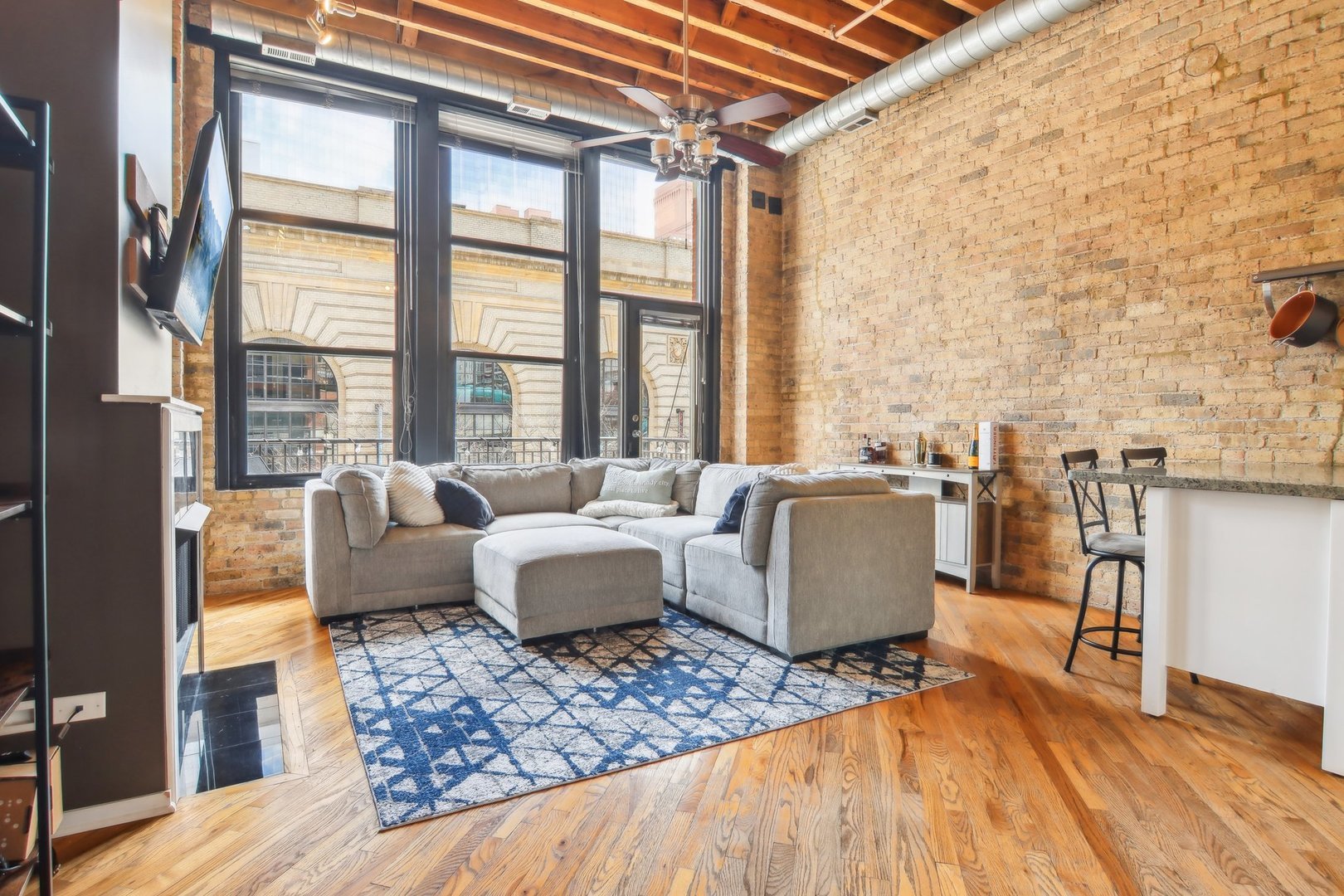 226 North Clinton Street, Unit 216 Chicago, IL 60661 - Photo 3 of 21 a living room with furniture and a floor to ceiling window