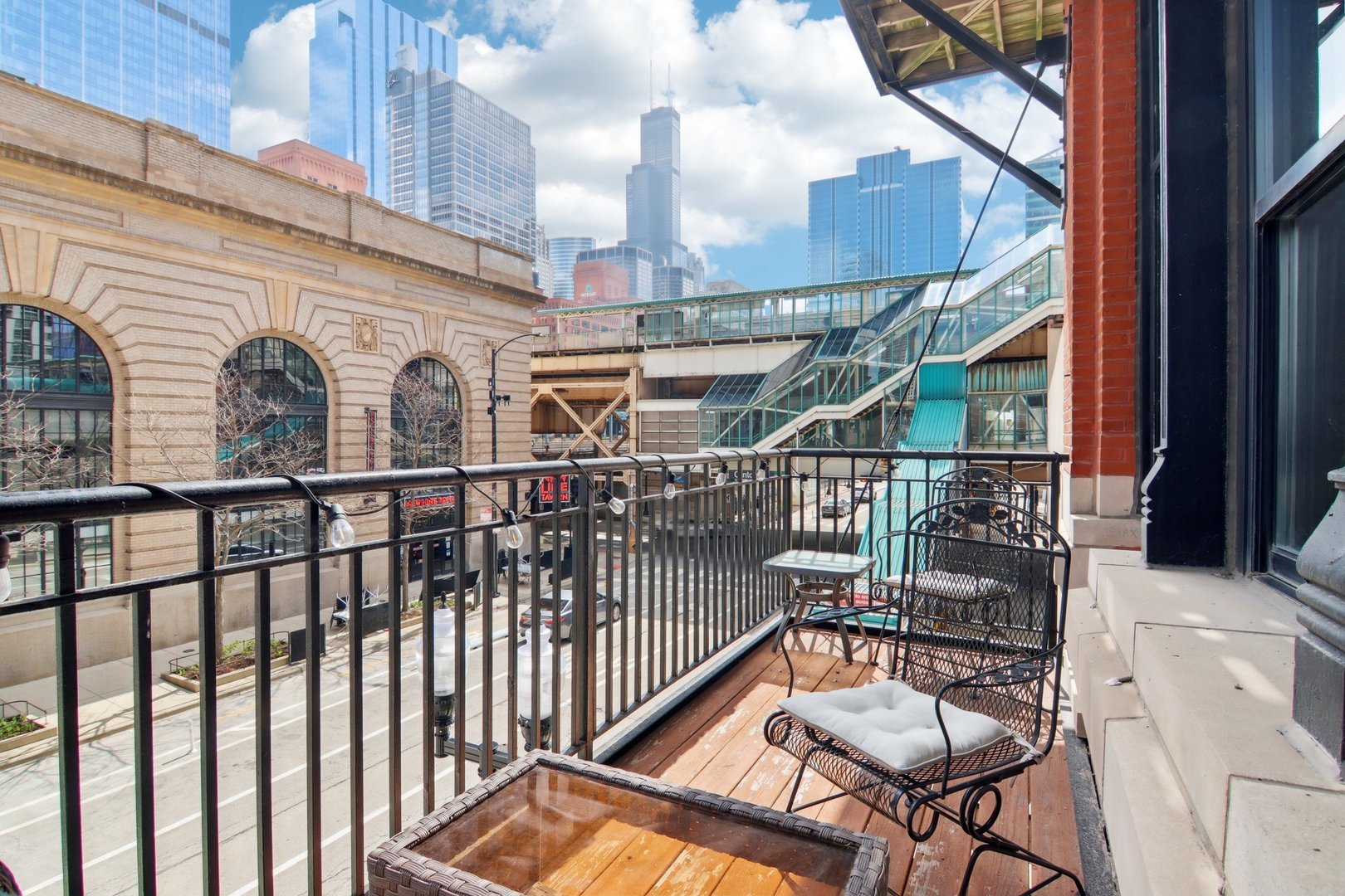 226 North Clinton Street, Unit 216 Chicago, IL 60661 - Photo 6 of 21 a view of a balcony with furniture