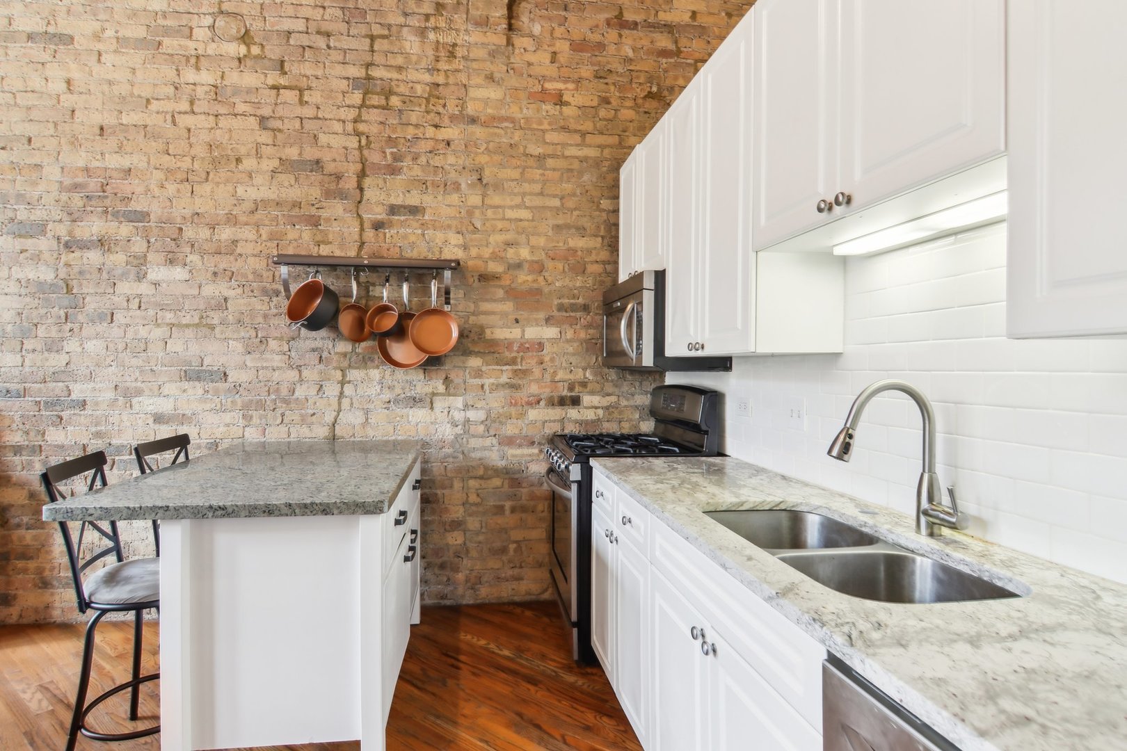 226 North Clinton Street, Unit 216 Chicago, IL 60661 - Photo 9 of 21 a kitchen with stainless steel appliances granite countertop a sink and cabinets