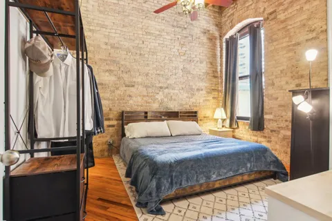 a bedroom with a bed and a chandelier