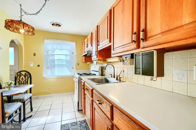 a kitchen with a sink appliances and cabinets