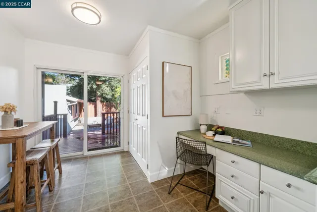 a dining room with furniture and a window