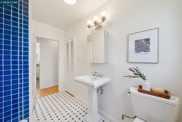 a view of a deck with wooden floor and fence with a large tree