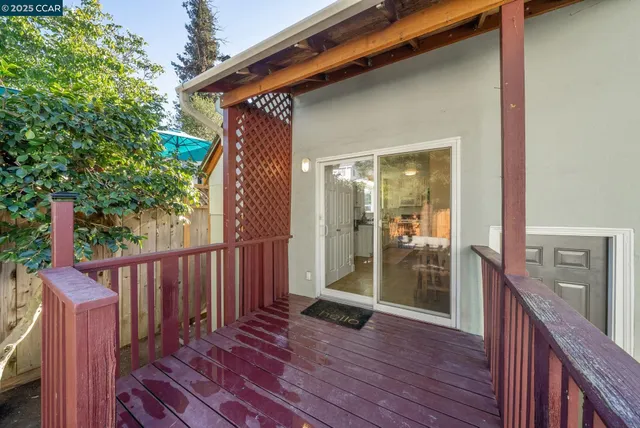 a view of a porch with wooden floor and fence