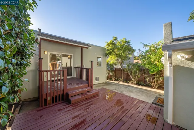 a outdoor living room with furniture and a potted plant
