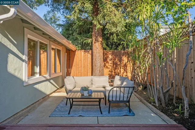 a view of a house with backyard and sitting area