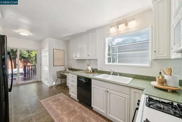 a kitchen with a sink stove and refrigerator